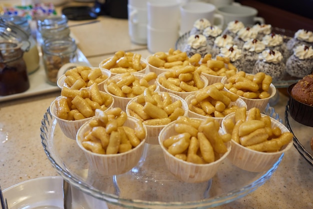 Cake anthill or chuckchuck with honey filling on the background of a table with another meal