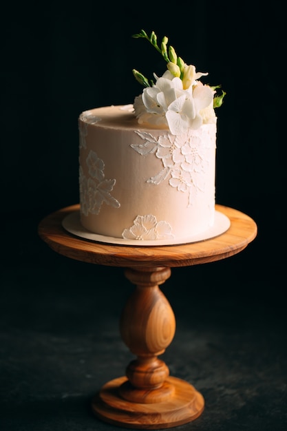 Cake is decorated with flowers on dark