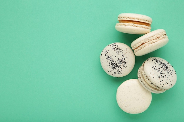 Cake macaron or macaroon on mint background Space for text