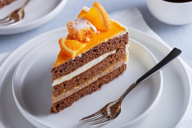 Cake orange and coffee on a light wooden table