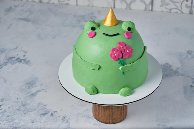 Cake in the shape of a frog with flowers Children's birthday cake