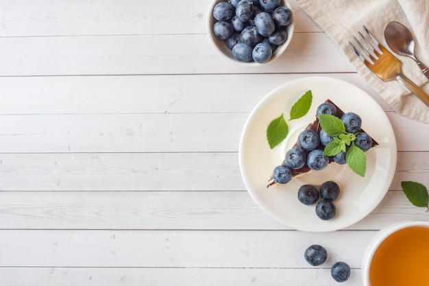 Cake of a souffle with glaze and fresh blueberries. Top view Cop