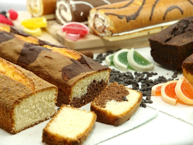 A cake with chocolate icing and a slice of cake on it