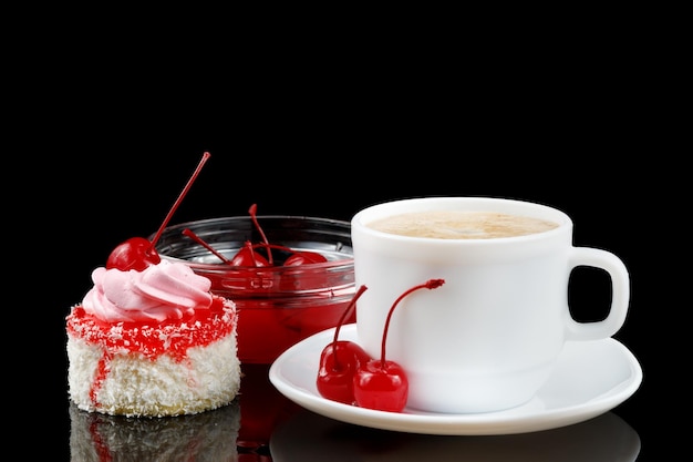 Cake with cream and cherry and coffee with milk