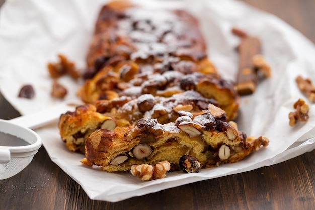 Cake with dry fruits and canned sugar on white paper