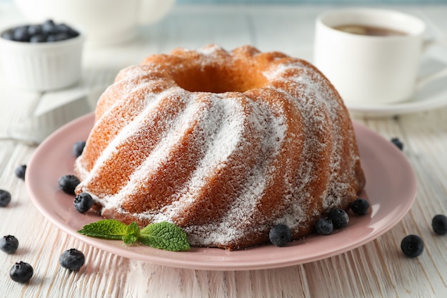 Cake with powder sugar and blueberry on table