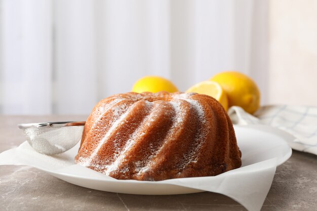 Cake with powder sugar on grey table