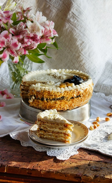 Cake with quark cream, vanilla, cheese cake from pastry with prunes and peanuts