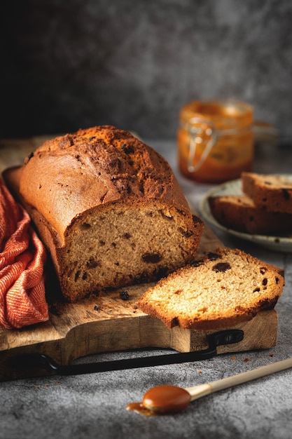 Cake with raisins on a wooden board, homemade baked goods with dried fruits