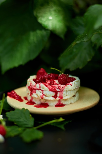 Cake with rice crisp bread and raspberry jam on a black background