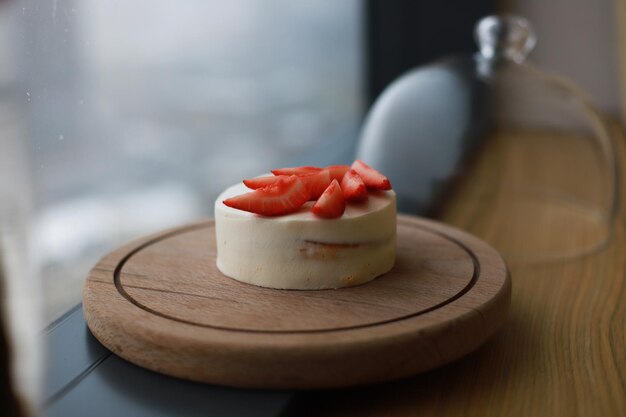 Cake with strawberries under a glass dome