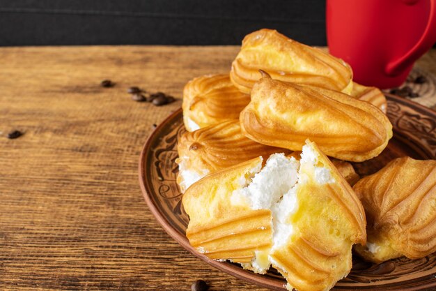 Cake with white protein cream and a cup of coffeeFood on the table Selective focus