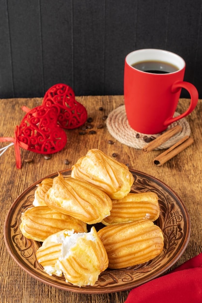 Cake with white protein cream and a cup of coffeeFood on the table Selective focus