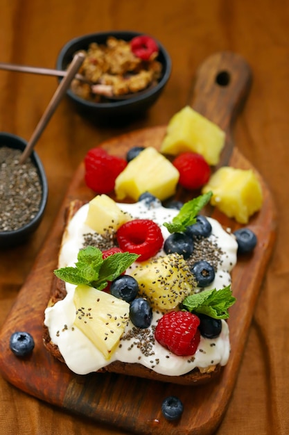 Cake with yogurt and fruits on a wooden board Summer dessert