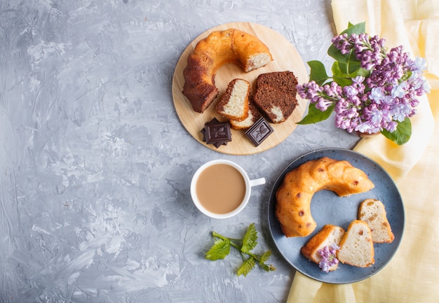 Cakes with raisins and chocolate and a cup of coffee, top view.