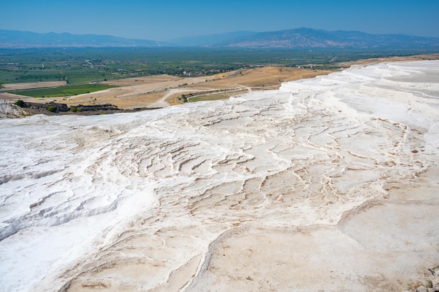 Calcite cliff of Pamukkale white travertines in Turkey