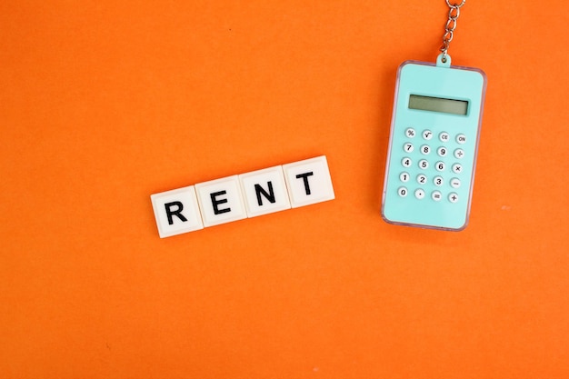 Photo calculator and alphabet letters with the word rent rental concept