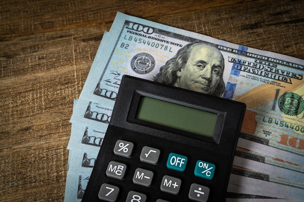 A calculator and dollar banknote.