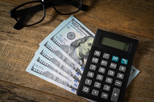 A calculator and dollar banknote.