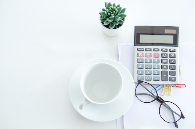 Calculator, a empty cup, glasses is ready for the business person to use