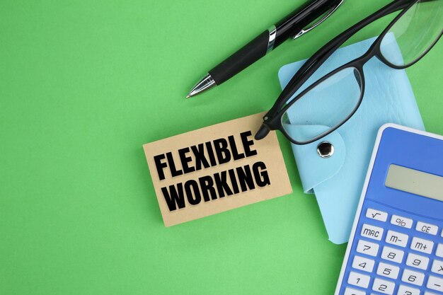 calculator glasses and pen with the word flexible working flexible working concept