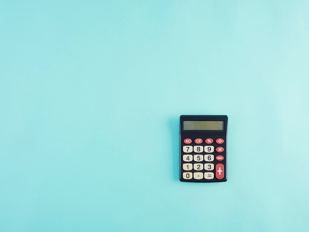 Calculator on light blue table