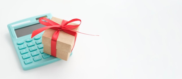 Calculator and shopping bag with gift boxes on a marble surface, copy space