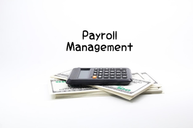 A calculator sits on top of a stack of money with the words paypal management on it.