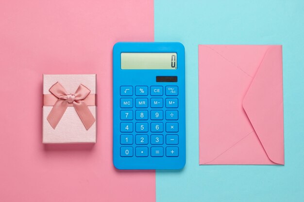 Calculator with envelope and gift box on pinkblue pastel