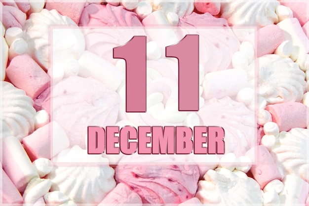 Calendar date on the background of white and pink marshmallows December 11 is the eleventh day of the month