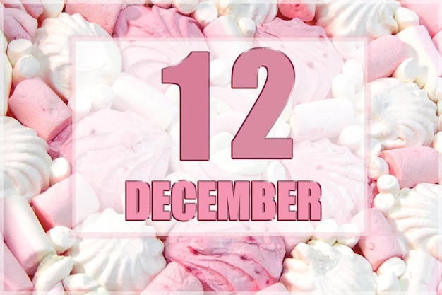 Calendar date on the background of white and pink marshmallows December 12 is the twelfth day of the month