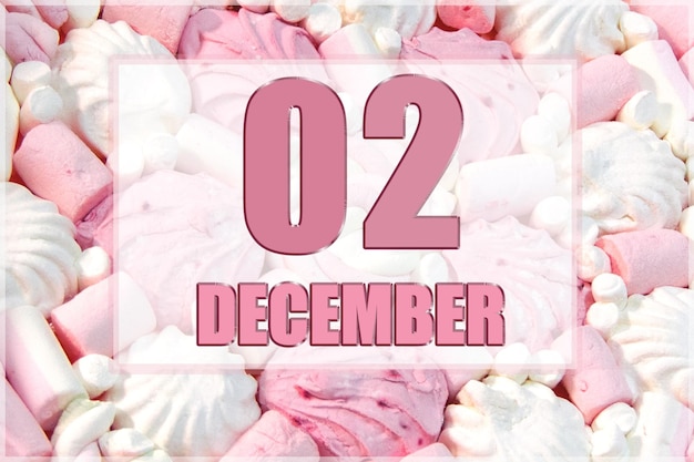 Calendar date on the background of white and pink marshmallows December 2 is the second day of the month