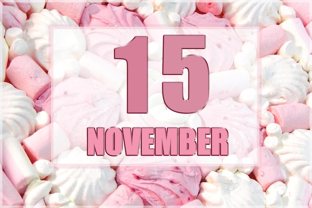 Calendar date on the background of white and pink marshmallows November 15 is the fifteenth day of the month