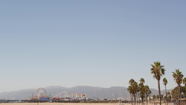 California beach aesthetic, ferris wheel on pier and palm trees in Santa Monica, Los Angeles USA