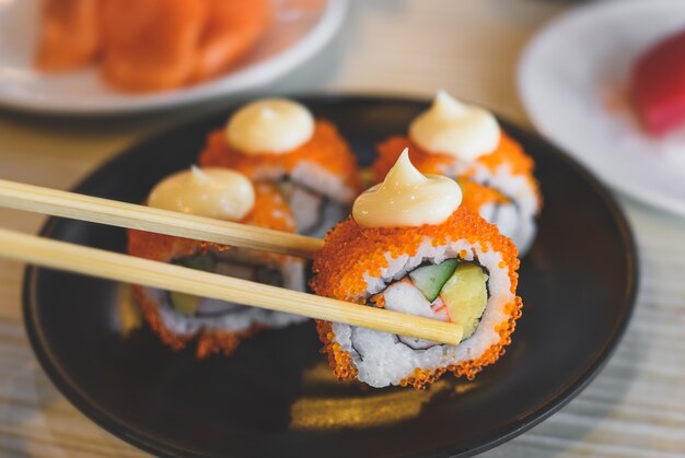 California roll and cut served in black plate