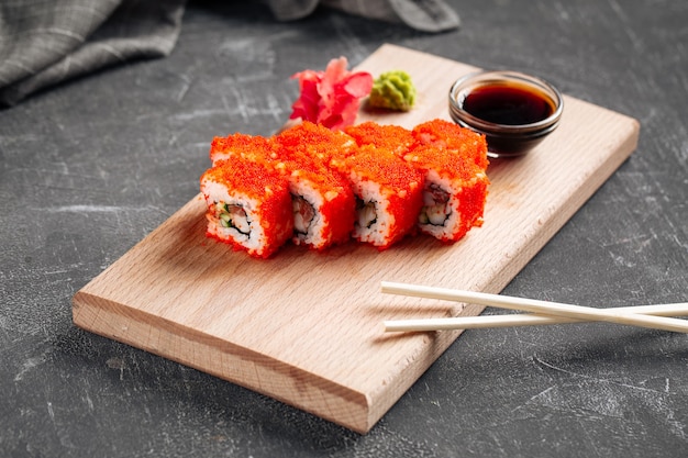 California sushi rolls with soy sauce on the wooden board