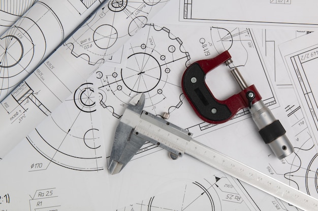 Caliper, micrometer and engineering drawings of industrial parts and mechanisms