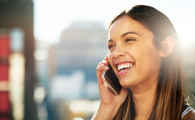 On the call anywhere anytime Shot of a beautiful young woman on a call outside