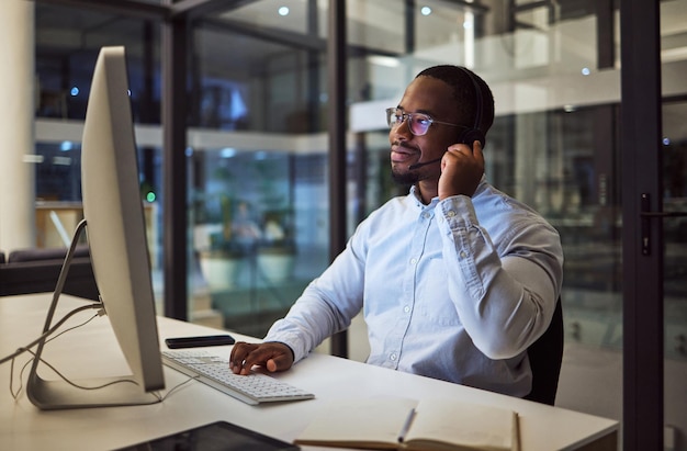 Call center CRM or customer service working black man with telemarketing or customer support in office Consultant contact us or help desk agent consulting support or advice with questions