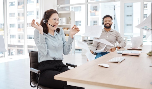 Call center customer service and excitement with a woman consultant celebrating sales at work on a headset Ecommerce contact us and crm with a surprised female happy at success in telemarketing