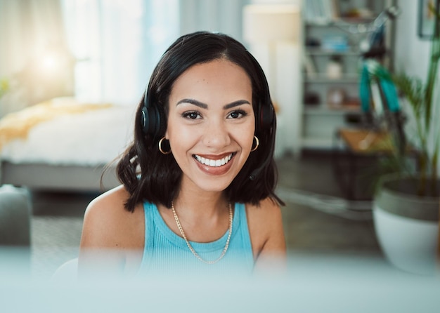 Photo call center customer service and sales support with a female agent or representative wearing a headset and remote working from home portrait of a young woman helping assisting or talking on a call