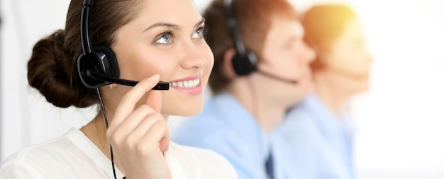 Call center. Diverse customer service operators in headsets at work in office. Business concept.