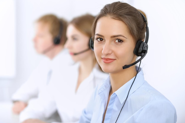 Call center. Focus on beautiful woman in headset.