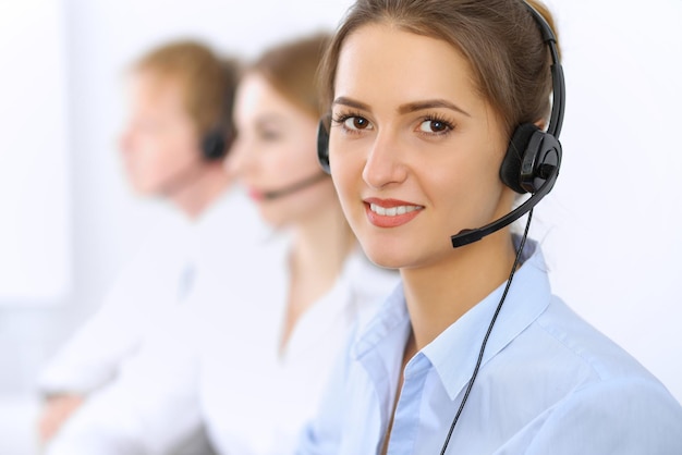 Call center. Focus on beautiful woman in headset.