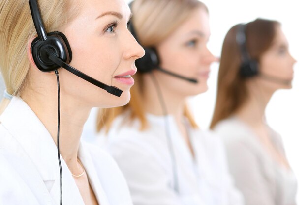 Call center. Focus on beautiful woman in headset.