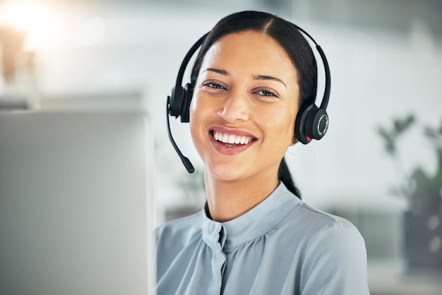 Call center headset and portrait of a happy woman at computer for customer service or sales Smile on face of consultant person at a pc for telemarketing crm or help desk and contact us support