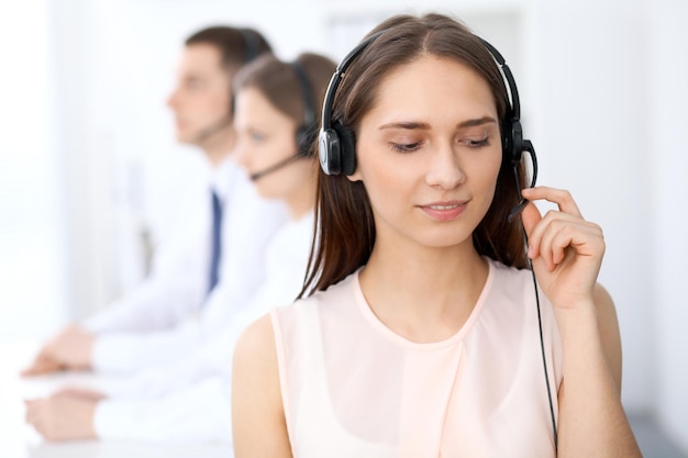 Call center operators Focus at young beautiful business woman in headset