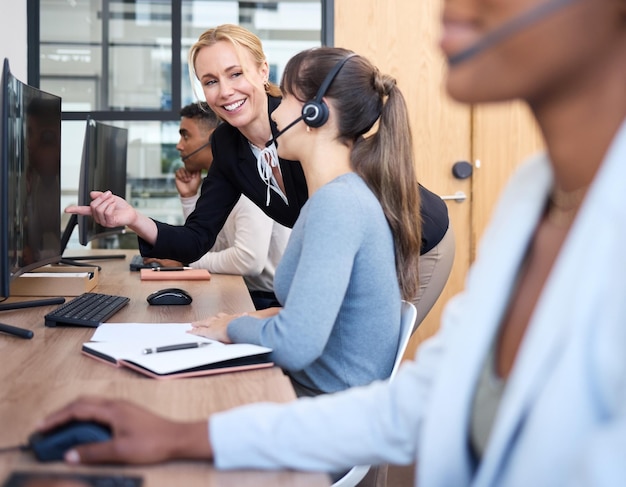 Call center pointing and woman with headset manager and customer service in office and hands CRM telemarketing and people with tech support speaking and agent on desk in agency and working