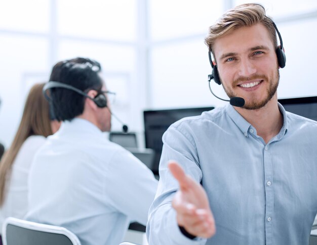 Call operator stretching out his hand for a handshake photo with copy space