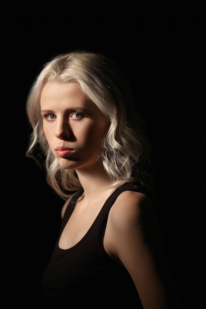 Calm girl with white hair and natural makeup on dark 